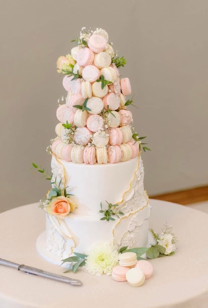 Croquembouche tower decorated with pink flowers