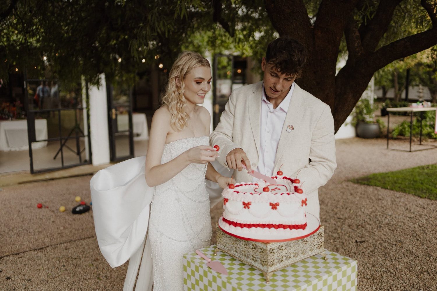 Couple with their wedding cake outdoors